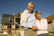 Senior couple in front of partially built house
