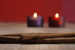 Christmas decoration with burning candle and cinnamon sticks