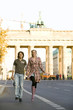 Young couple running in street, hand in hand
