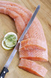 Salmon fillet on chopping board, elevated view