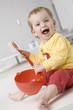 Baby girl (2-3) with bowl and brush