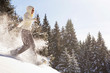 Woman snowshoeing in mountains