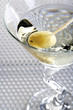 Glass of Martini with green olive, close-up