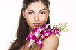 happy young woman with orchid on white background