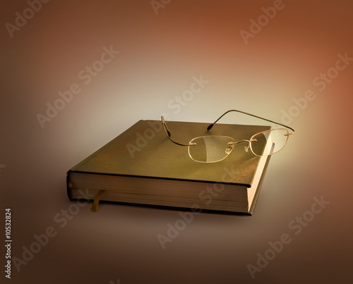 Photo: Glasses lying on the old book Glasses lying on the old book