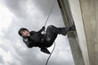 SWAT Team Officer Rappelling from Building