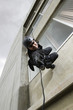 SWAT Team Officer Rappelling from Building