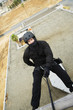 SWAT Team Officer Rappelling from Building
