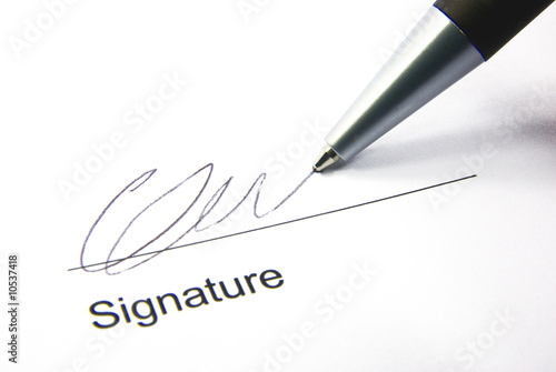 Photo: Detail view of the signature box of a contract with a pen. Detail view of the signature box of a contract with a pen.