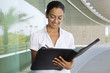 Young Woman Writing in a Planner