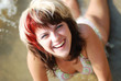Happy young woman on the beach of the river