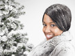	Woman next to a fir-tree, smiling