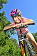 Photo: Portrait of a teenage girl on a bicycle in summer park outdoors Portrait of a teenage girl on a bicycle in summer park outdoors