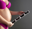 pregnant woman carrying her child's ultrasound picture