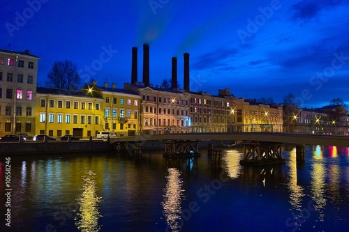 Night cityscape with old houses and stacks