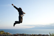 happy businessman jumping high at the hill