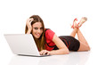 Happy woman using laptop on floor.