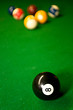 american pool balls on geen snooker table.
