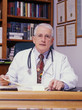 a doctor tat his desk in his hospital office