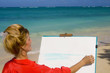 a female artist painting on the beach in Hawaii