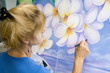 A female artist painting on canvas in her studio