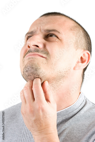 Photo: handsome young man scratching his beard handsome young man scratching his beard