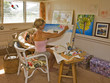 A female artist painting in her studio