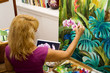a female artist painting in her studio