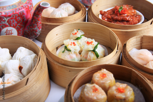 Photo: variety of dim sum in bamboo steam containers variety of dim sum in bamboo steam containers