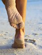 Women's legs on a beach
