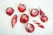 An image of christmas ornaments in snow