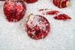 An image of christmas ornaments in snow