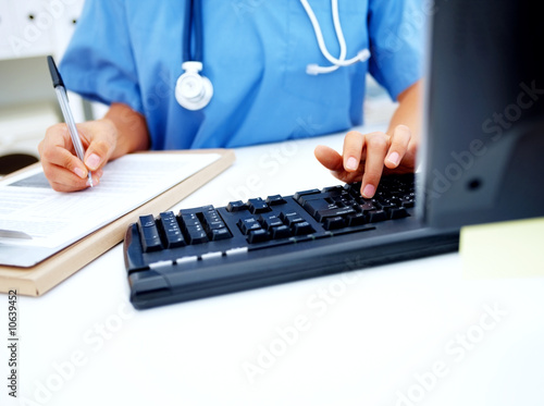Photo: Medical - Nurse working at desk Medical - Nurse working at desk