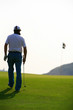 golfer walking towards the hole