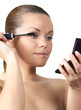 Woman painting eyelash (isolated on white)