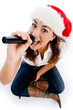 Photo: model holding karaoke and wearing christmas hat model holding karaoke and wearing christmas hat