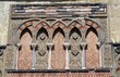 decorative wall with mosaic pattern, arches, & pillars