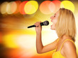 Beautiful young singer on abstract background