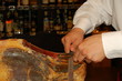 cook cuts jamon meat, wild hog leg