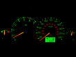 Close up of a car dashboard gauges at night