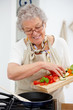 Grandma preparing a meal in the kitchen Grandma preparing a meal in the kitchen