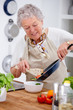Grandma serving a healthy meal in kitchen Grandma serving a healthy meal in kitchen