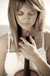 young thoughtful beautiful woman with a violin