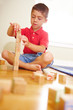 Boy playing with cube boxes