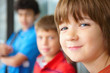 Closeup of a happy young boy with friends in backgrounds