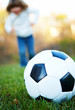 Young Kid playing outdoors with football