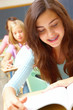 Photo: Cute small girl sitting in classroom and studying Cute small girl sitting in classroom and studying