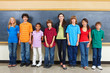 Photo: Portrait of students standing in a classroom with blackboard in Portrait of students standing in a classroom with blackboard in
