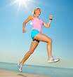 Woman jogging by the sea on a sunny day