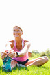 Smiling woman exercising on a grassy land